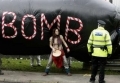 A protester stands in front of an inflatable 'bomb' 