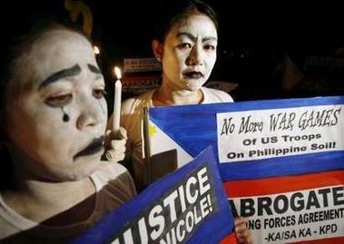 Protesters hold anti-U.S. placards during a candlelight protest in Manila 