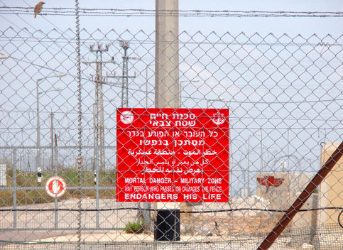 A sign posted on the fence near the Elkana settlement. (Amer Madi)